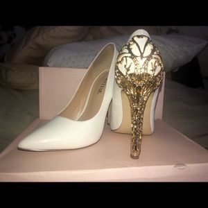 White pumps with a gold heel